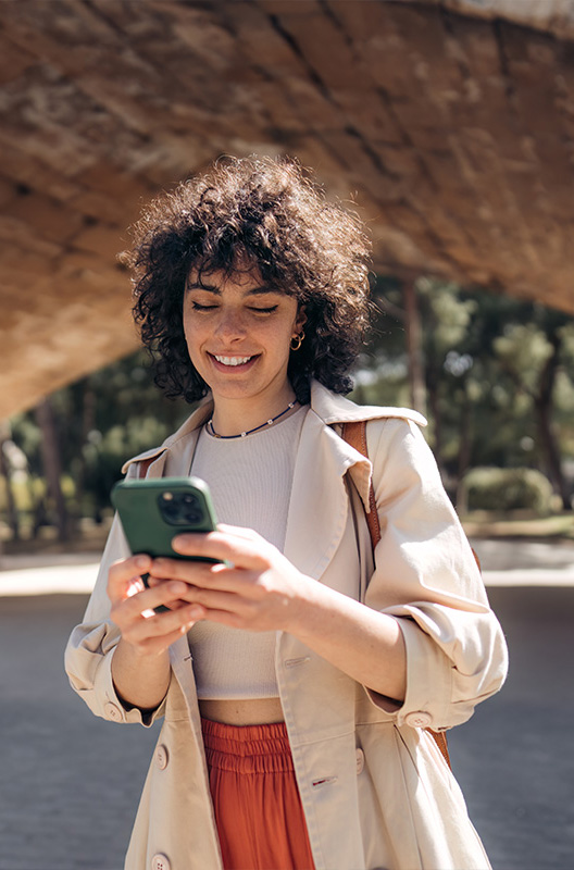 Young person using a phone in the city